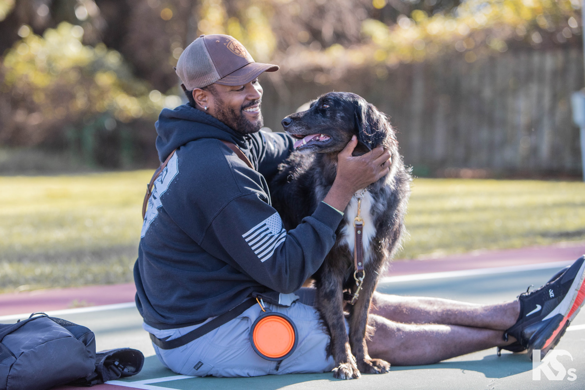 A veteran smiling with his service dog
